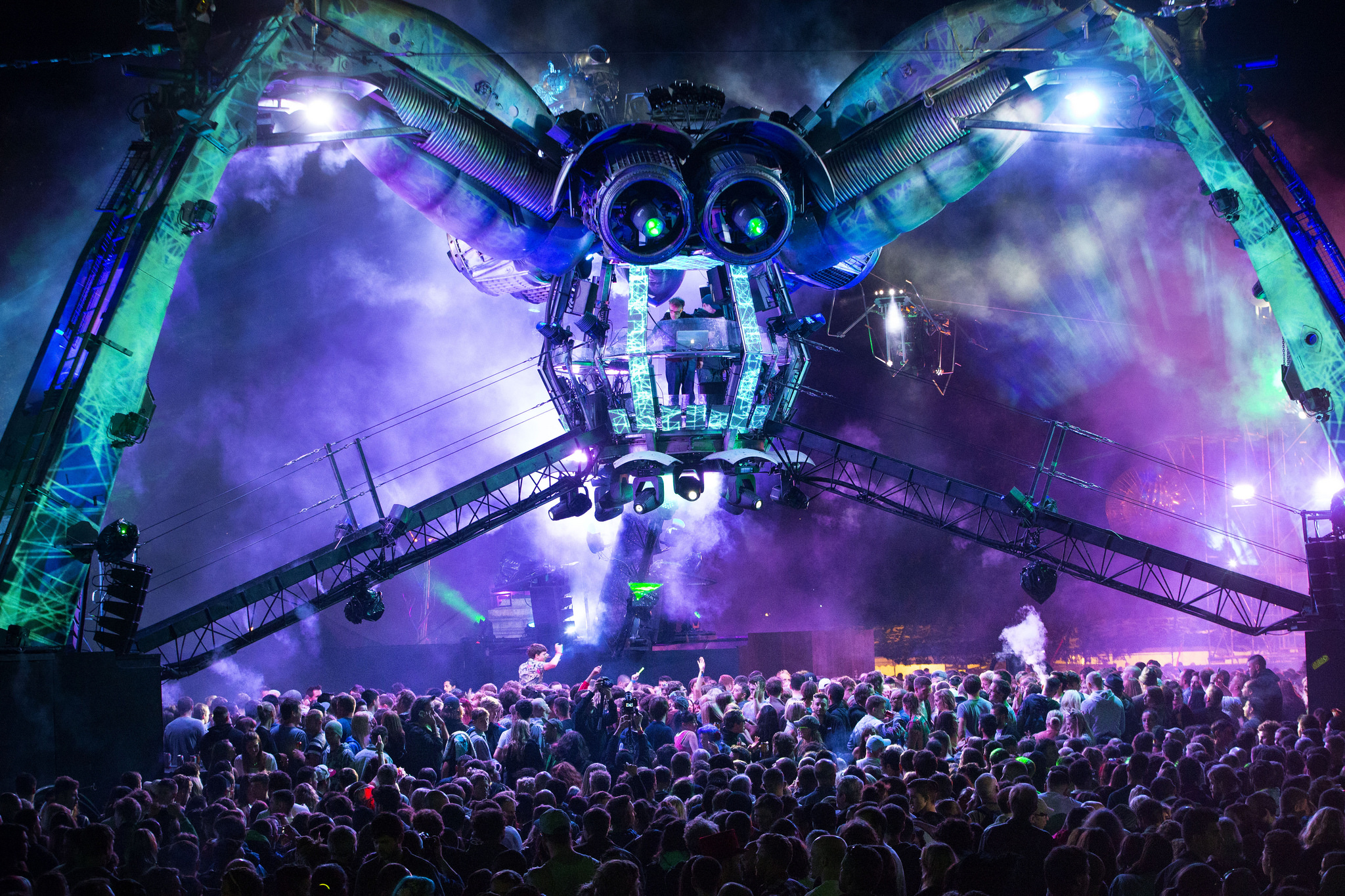 Purple mechanical spider in a crowd of people
