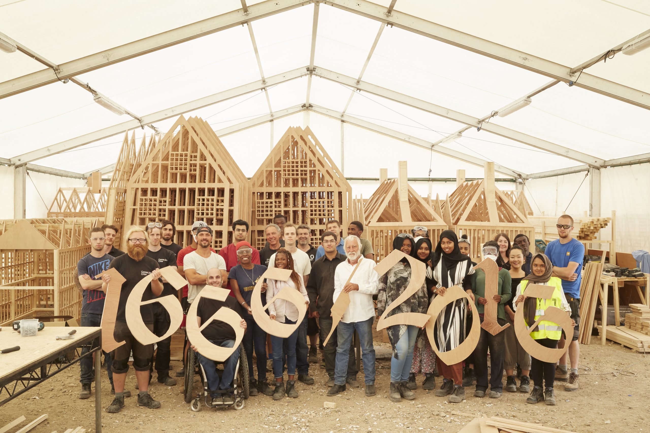 London 1666 participants and artist David Best holding up wooden numbers which say 