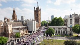PROCESSIONS crowds in white, violet and green against the backdrop of Westminster in London.