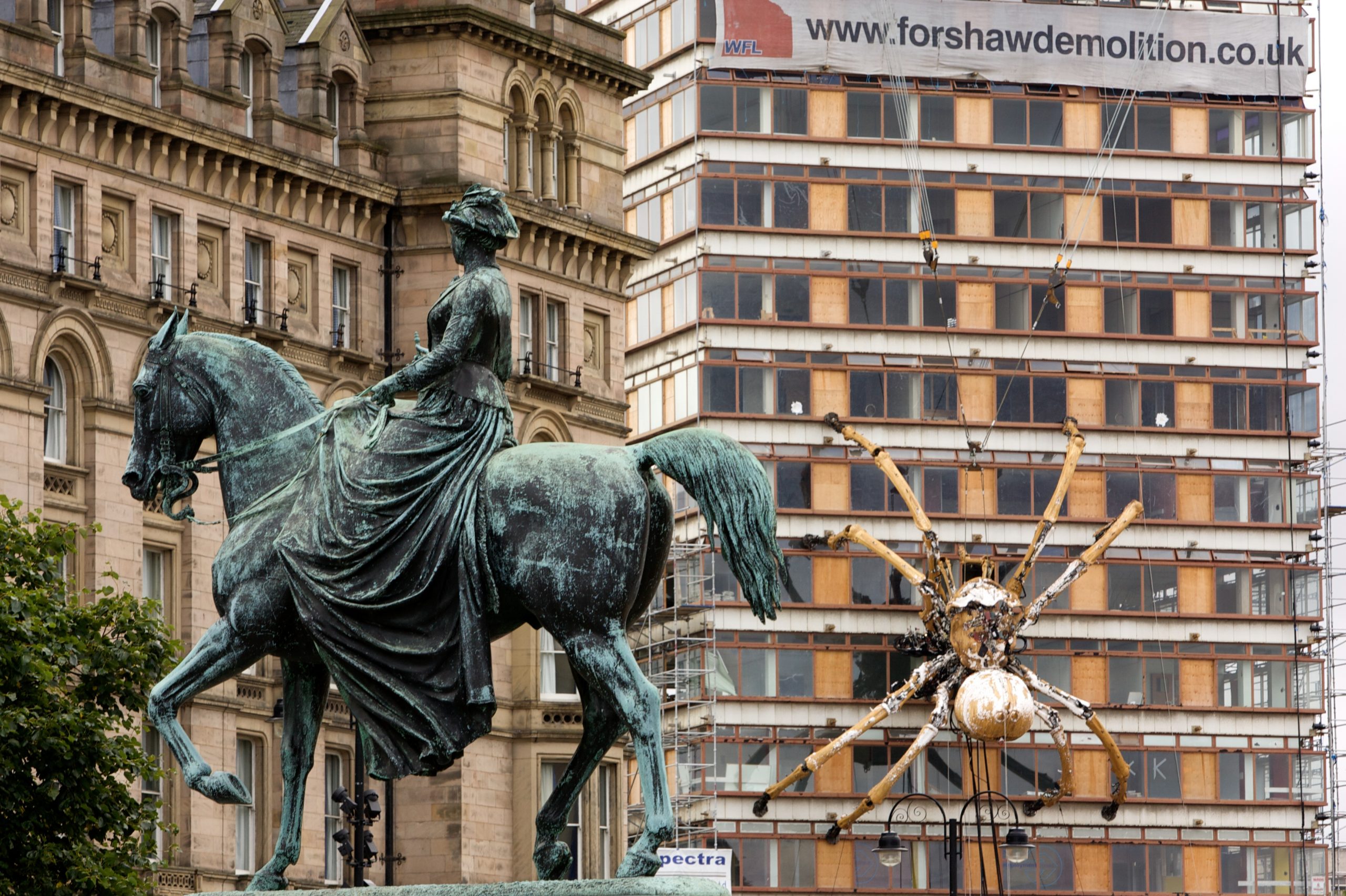 A giant mechanical Spider climbing a building in Liverpool