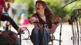 Child smiling riding on the magical menagerie