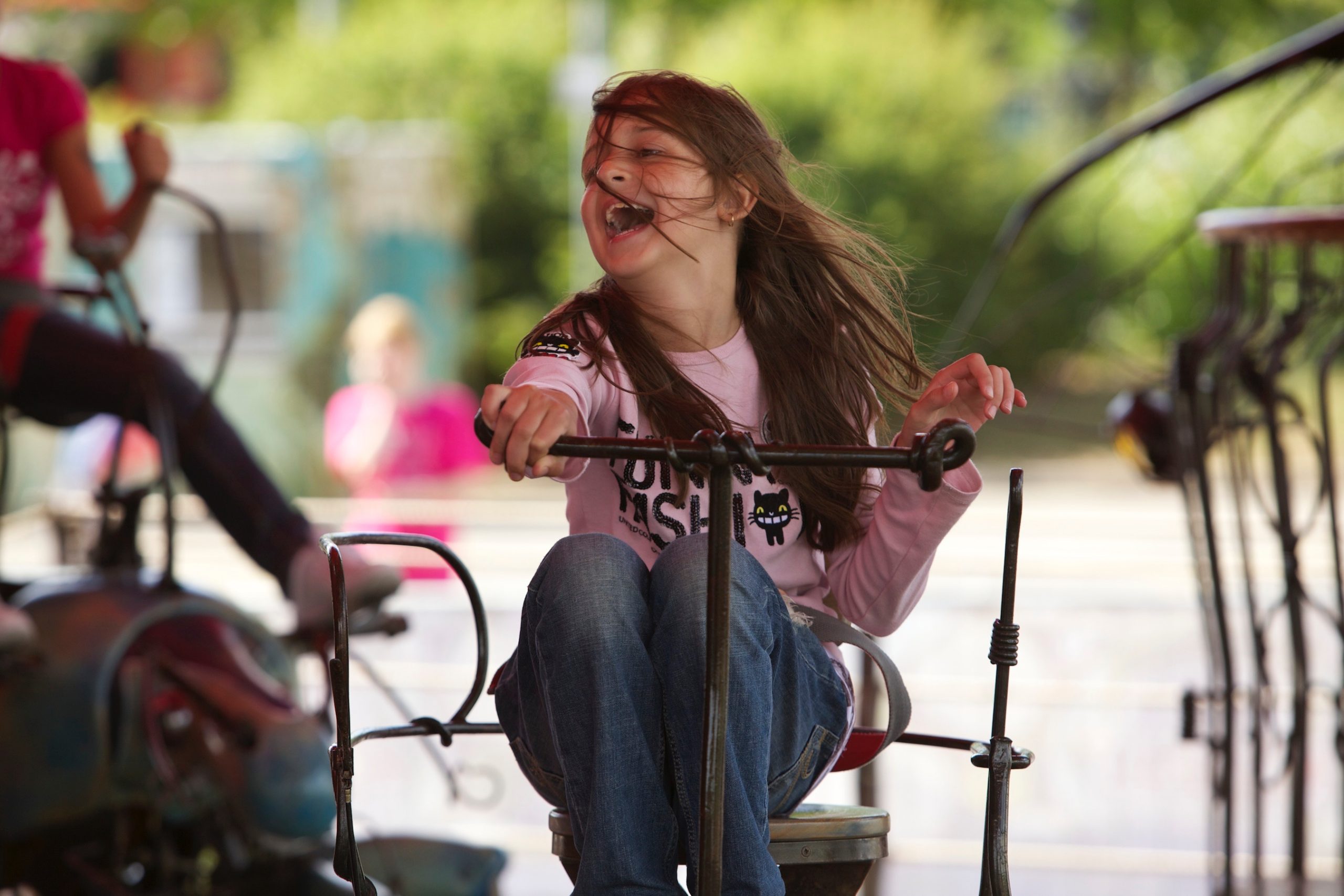 Child smiling riding on the magical menagerie