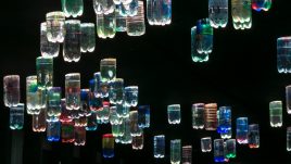 Bottles of water reflecting light with a rainbox