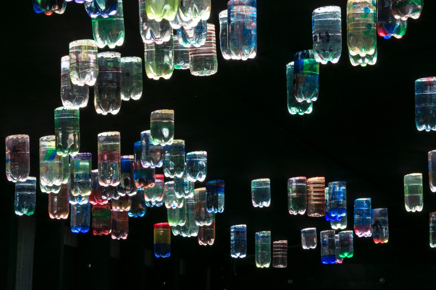 Bottles of water reflecting light with a rainbox