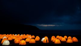 Peace Camp at Cliff Beach, Valtos, Isle of Lewis at night, silhouette of a person in front of one of the tents