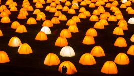 Peace Camp at Dunstanburgh Castle. Two silhouettes of people in front of one of the tents