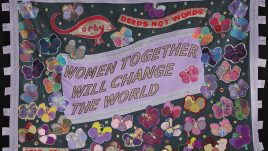 This banner celebrates the individual and collective strength, grace and intelligence of women, especially the women of Corby. The violets were chosen as a symbol of growth, hope and inspiration. Together, the group became a ‘creative voice’ for women of all ages and backgrounds by sharing their past and present, as well as their hopes and aspirations for the future. ‘Deeds Not Words’ is also the town motto of Corby, so it was important to the group that it was included, especially given its connection to the Suffragette movement.