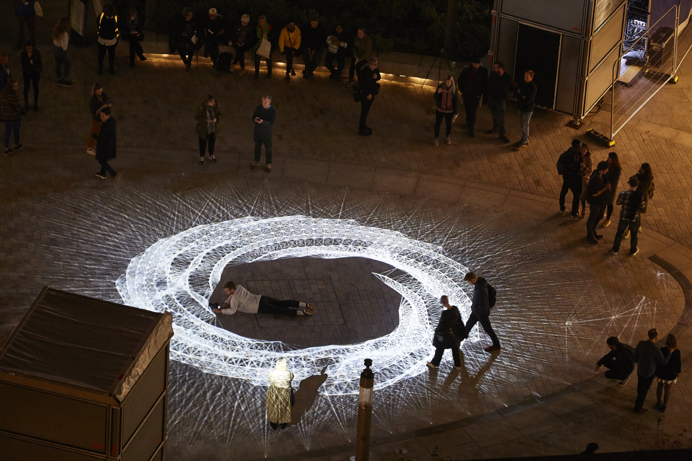 Light installation Hidden Voices: PROCESSIONS in the City at night in Aldgate Square