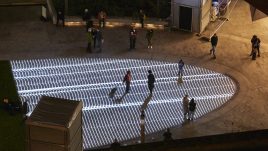 Light installation Hidden Voices: PROCESSIONS in the City at night in Aldgate Square