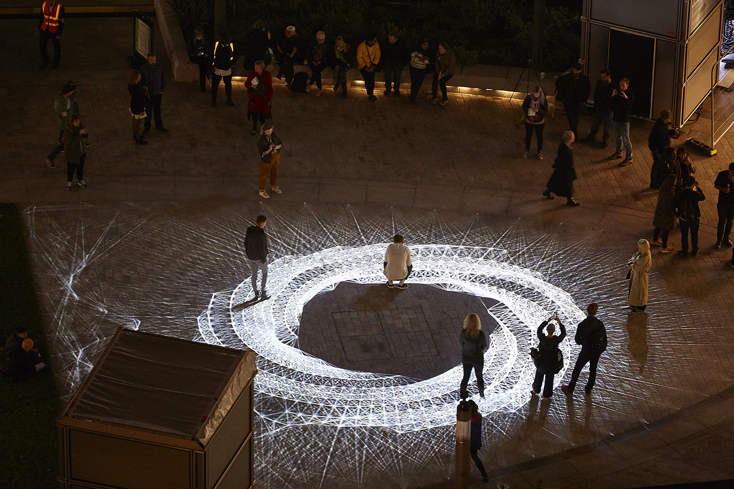 Light installation Hidden Voices: PROCESSIONS in the City at night in Aldgate Square