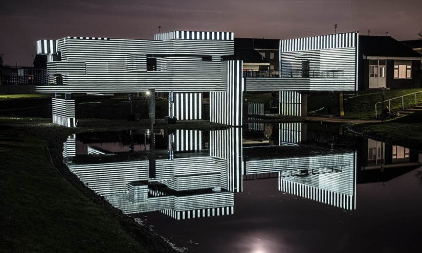 Apollo 50 Geometric structure illuminated in monochrome light.