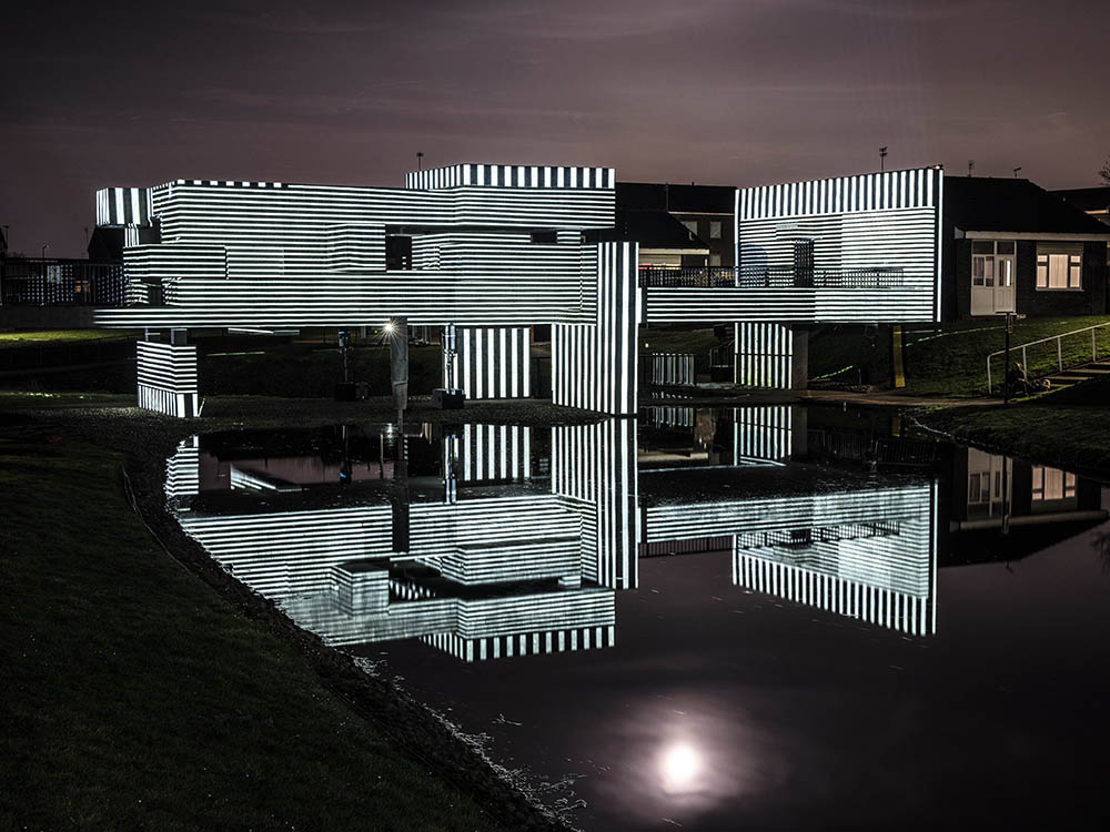 Apollo Pavilion illuminated in striped monochrome light.