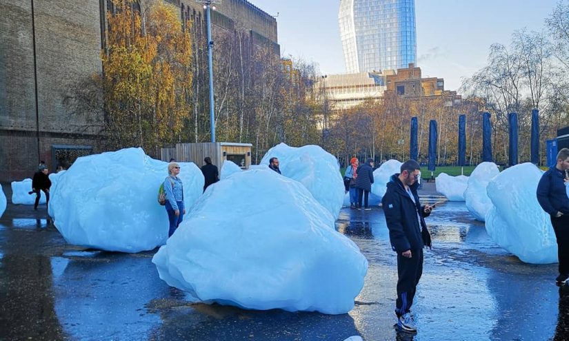 People around giant glacial ice blocks outside of the tate modern