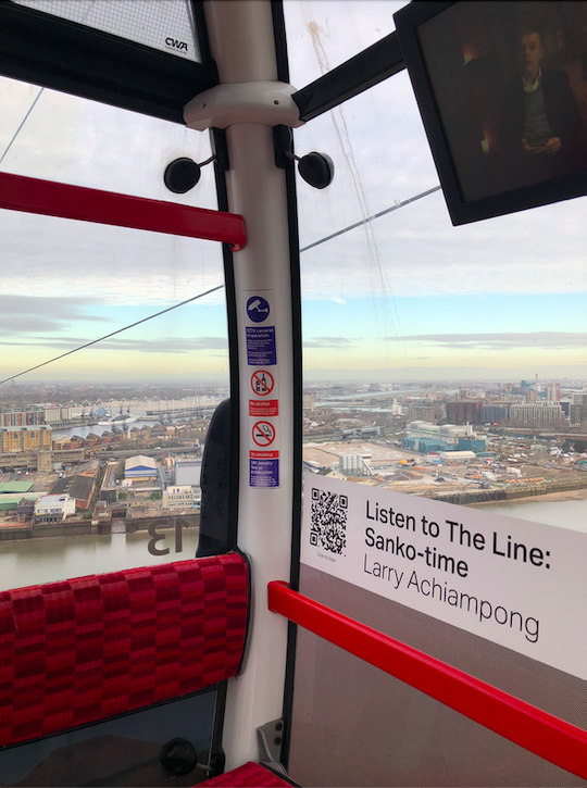 Image of the corner of the Emirates Skyline. There is a view of the river and the city and a label in the carriage with a QR code, next to it says 