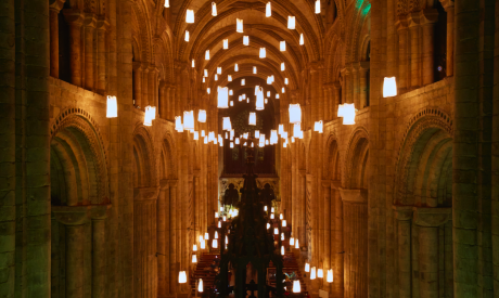 Glowing lanterns floating in the centre of a cathedral
