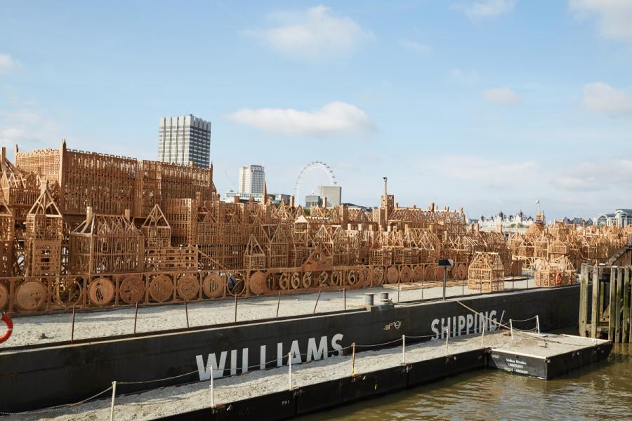 Wooden London 1666 structure atop a boat on the River Thames