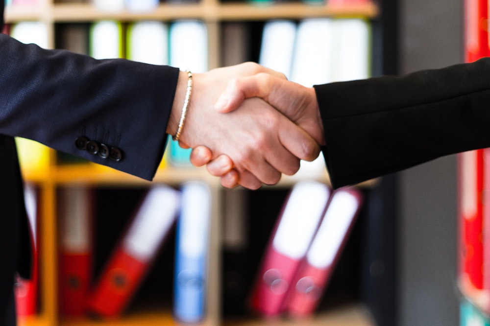 Close-up of two people shaking hands.