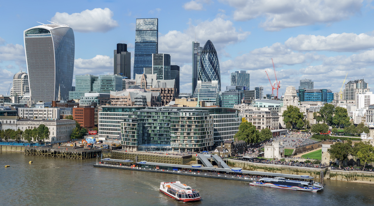 Towers and skyscrapers in The City of London on the riverside on a sunny day