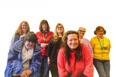 Collage of six members of the Northern Butterflies and the founder Samantha, they are all dressed in colourful clothes and some of the members are wearing sunflower lanyards