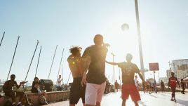 basketball players playing a match in the late afternoon sun