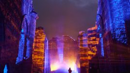 A projection of blue and orange lighting and fog at Finchale Priory in Durham