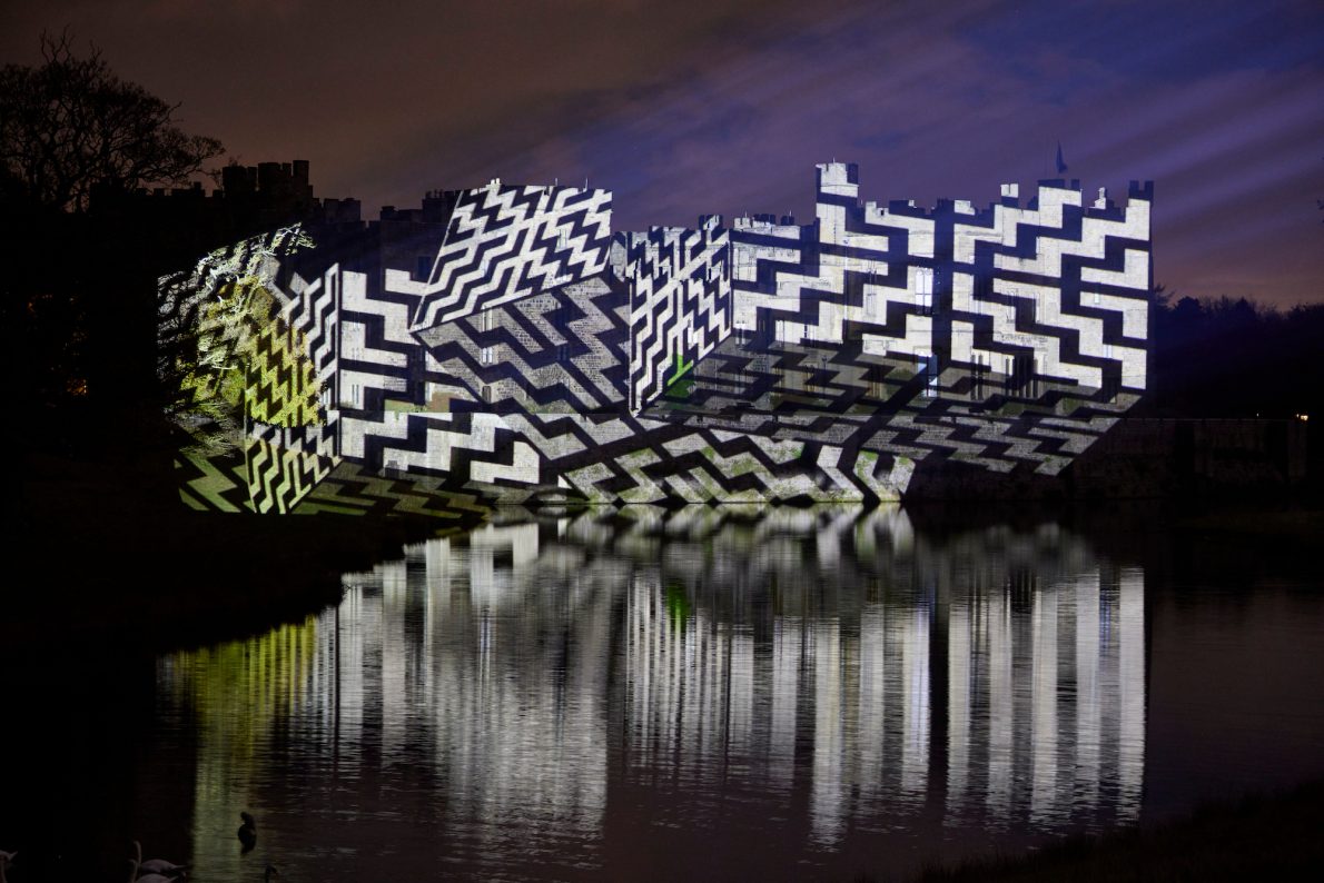 Raby castle with a geometric light projection on it