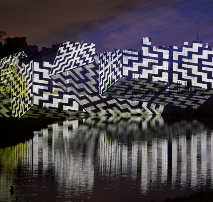 Raby castle with a geometric light projection on it