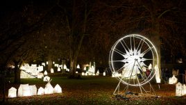 Lit up lanterns of houses and a ferris wheel