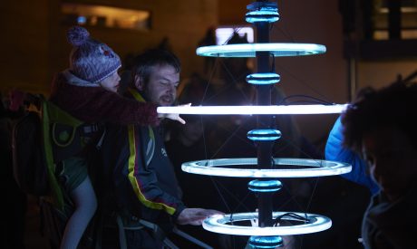 Pole with blue halos, an interactive artwork that lights up in blue when you touch it