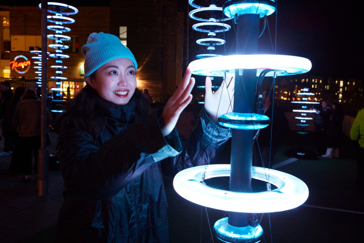 Pole with blue halos, an interactive artwork that lights up in blue when you touch it