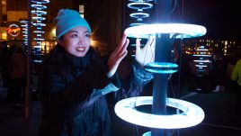 Pole with blue halos, an interactive artwork that lights up in blue when you touch it