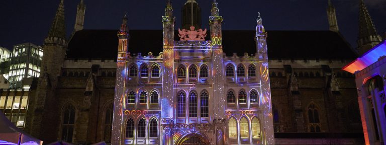 The facade of the Guildhall lit up with a multicoloured installation that is animated based on the music from someone playing the grand piano