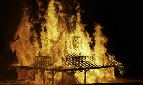A huge wooden structure burning