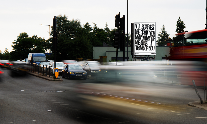rzd’Like I think of you’, Anya Naumovic, The Gallery, Season 1, 2022. Produced by Artichoke. Photo by Mass Media Photo of art by Anya Naumovic on a billboard; Black and white hand printed letters spelling