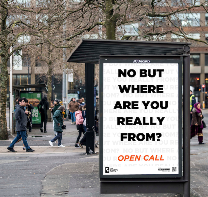 A bus shelter screen displaying the words: NO BUT WHERE ARE YOU REALLY FROM? OPEN CALL.