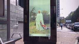 An image of a bus stop digital screen showing the artwork ‘Brit-ish’ (2023) by Azraa Motala.