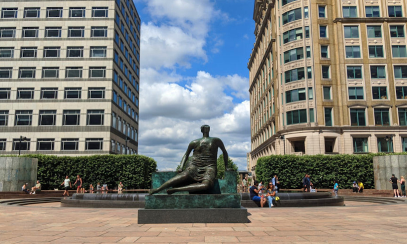 Henry Moore's sculpture 'Draped Seated Woman' seen in Canary Wharf on a bright day. 