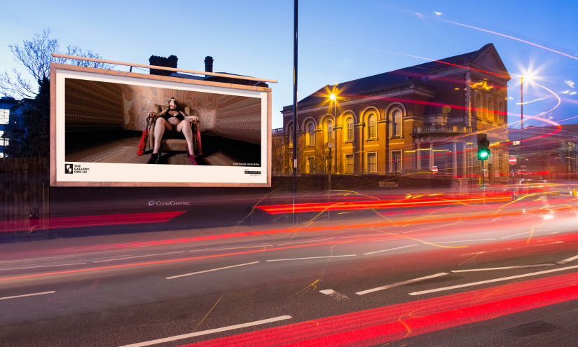 A roadside billboard at night showing the artwork; ‘The Kitchen Cupboard’ (2022), Frances Willoughby.